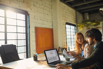 Diverse group of young designers working on project in office