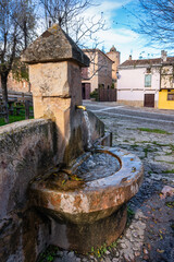 Water fountain made of ancient stone in the medieval village of Palazuelos, Guadalajara.