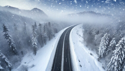 Fototapeta premium Aerial view of snow-covered highway in the mountains.