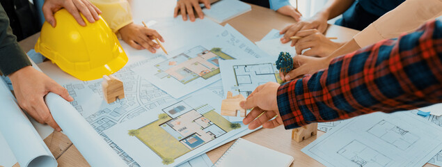 Professional architect cooperate with engineer discussing the use of green design in eco house...