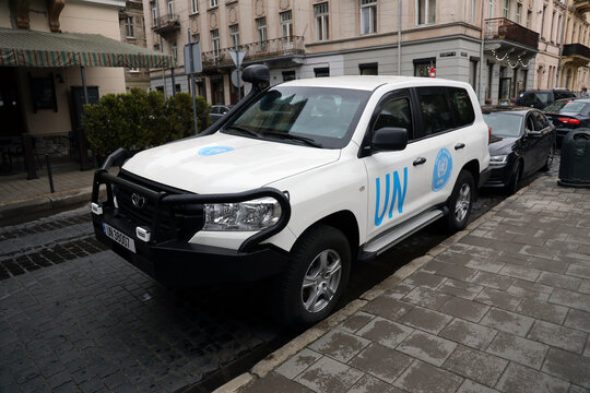KYIV, UKRAINE - 4 MAY, 2023: Logo of UN United Nations OCHA on doors of white SUV car close up