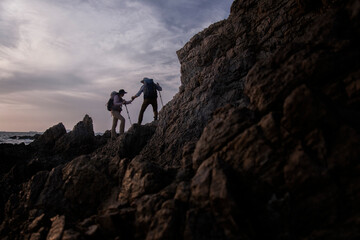 silhouette of a person on a rock. climber on the top. climber on the top of the mountain. climber on the top of mountain.