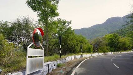 Outdoor traffic convex mirror in the hairpin bends and uphill road enroute to kodaikanal hilltop - obrazy, fototapety, plakaty