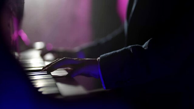 talented musician playing piano in dark nightclub, jazzman playing melody and improvisation, closeup