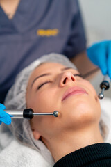 close-up of a beautician doctor massaging the skin of a client's face during a beauty and health cosmetic procedure
