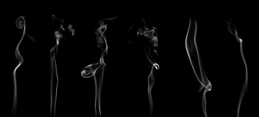 White smoke or steam smog moves on a black background. Beautiful gray smoke 
