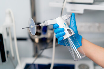 close-up of an ENT doctor holding a professional endoscopy device in a gloved hand in a clinic