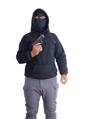 Unidentified male criminal wearing a black hoodie and covering his face, holding a pistol and...