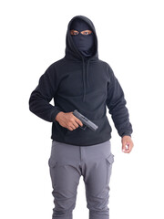 Unidentified male criminal wearing a black hoodie and covering his face, holding a pistol and...