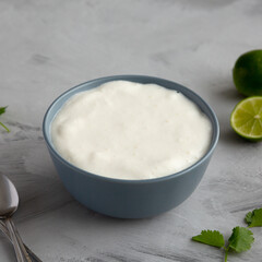 Homemade Mexican Crema Sauce in a Bowl, side view.