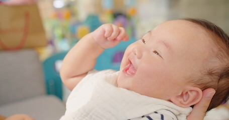 Happy Mother and baby playing bonding activity together in living room. little cute Asian baby infant child girl excited laughing and fun spend quality time, Family having fun at home