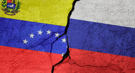 Venezuela and Russia flags on a stone wall with a crack, illustration of the concept of a global crisis in political and economic relations