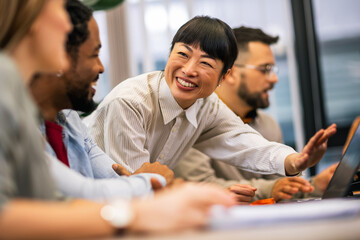 Portrait of young Asian business woman smiling in the modern office.