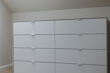 White Dresser Finesse: Detailed Shot in a Chic Wardrobe Room
