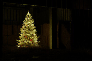 a festively decorated and brightly lit Christmas tree in a barn - 3D Illustration