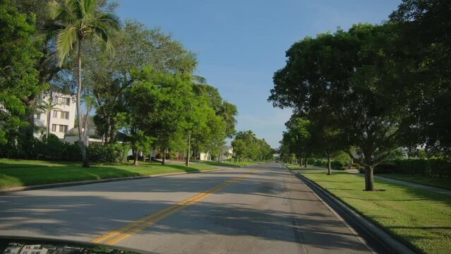 Wde view POV car driving on street in Naples Florida. road with cars in traffic 