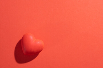 Fototapeta premium Valentines day. Red heart with copy space isolated on red