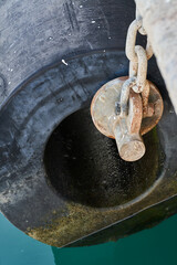 Chains stand fenders dock bumpers in sea port