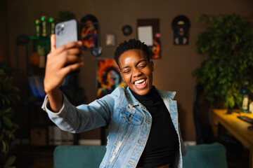 Stylish successful afro american young woman vlogger blogger having online live stream talking with followers subscribers.