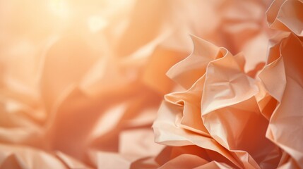 Crumpled paper in Peach Fuzz color, background with selective focus and copy space for text. The trending color of 2024.