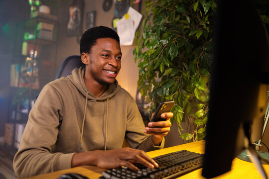 Happy delighted African American dark skinned man social media influencer taking a break from shooting content for his channel.