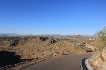 Distant view of Scottsdale and North Phoenix as seen from a paved road in Northern Mountain park