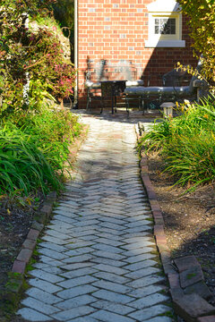 Herringbone style pattern of bricks used as a path leading to a house in Fredericksburg, Virginia