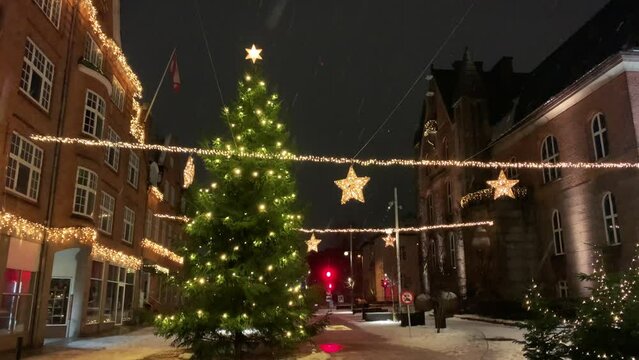  Decorated for Christmas holidays, Denmark, Copenhagen , Viborg, Shopping street in historical center of Aarhus decorated for New Year holidays, Pedestrians Christmas shopping on Stroget at night.
