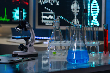 In the close up shot, the laboratory room is shown. On the table there is a microscope, test tubes...