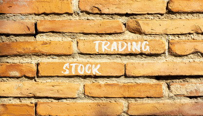 Stock trading symbol. Concept words Stock trading on beautiful brown brick wall. Beautiful brown brick wall background. Business stock trading concept. Copy space.