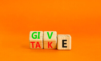 Give or take symbol. Concept word Give or Take on wooden cubes. Beautiful orange table orange...