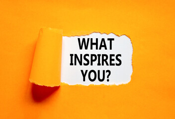 What inspires you symbol. Concept words What inspires you on beautiful white paper. Beautiful orange background. Business motivational what inspires you concept. Copy space. - obrazy, fototapety, plakaty