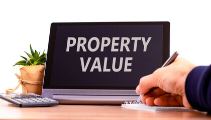 Property value symbol. Concept words Property value on beautiful black tablet. Beautiful white background. Calculator. Businessman hand. Business property value concept. Copy space.