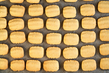 Freshly baked Christmas cookies on a sheet of baking paper