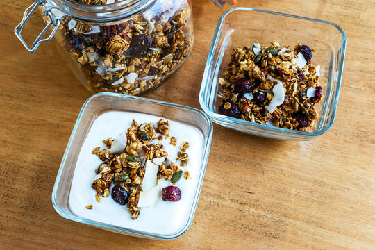 Granola with milk and fresh berries in a white bowl