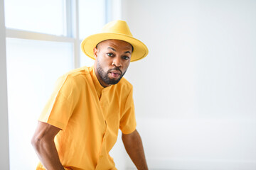 young adult american man standing at home background with fashion clothes