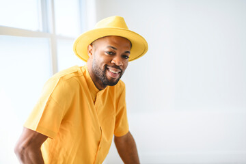 young adult american man standing at home background with fashion clothes