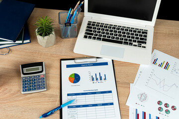 business data  note book, laptop mouse graph paper document calculator for  successful analyst