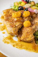 chicken breast with cape gooseberry sauce, green rice and fruit salad