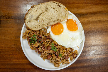 Colombian breakfast with bread, eggs and warmed rice