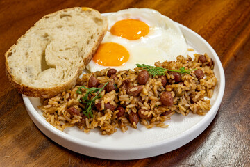 Colombian breakfast with bread, eggs and warmed rice