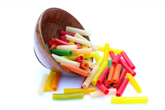 Mixed colour fryums out from wooden bowl 
