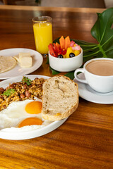 Colombian breakfast with arepas, coffee, bread, eggs, warmed rice and fruit