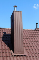 Chimney on the roof of the house.