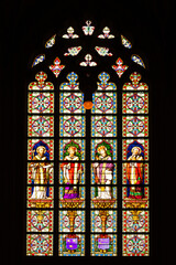 Stained glass window depicting a saint performing the sacrament of Holy Communion in St. John's Cathedral, in den Bosch, Netherlands.