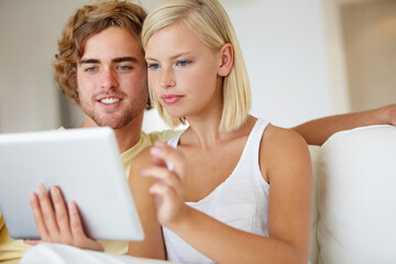 Obraz na płótnie Canvas Smile, tablet and young couple on sofa browsing on social media or internet at apartment. Relax, digital technology and happy man and woman from Australia scroll on website in living room at home.