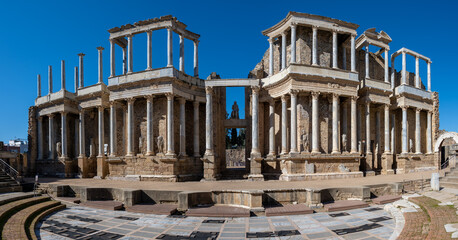 Panoramic view of the ancient Roman theater ruins of Merida, Spain under clear blue sky. - obrazy, fototapety, plakaty