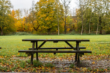 Picnic table in a public park during autumn season