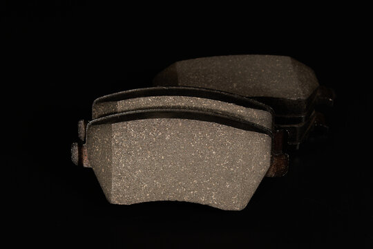 New brake pads on a black background.