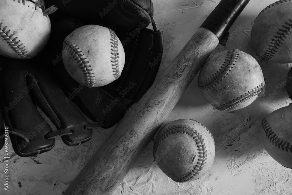 Wall mural baseball equipment flat lay with aged balls and glove as sports background art in black and white. - Wall murals
